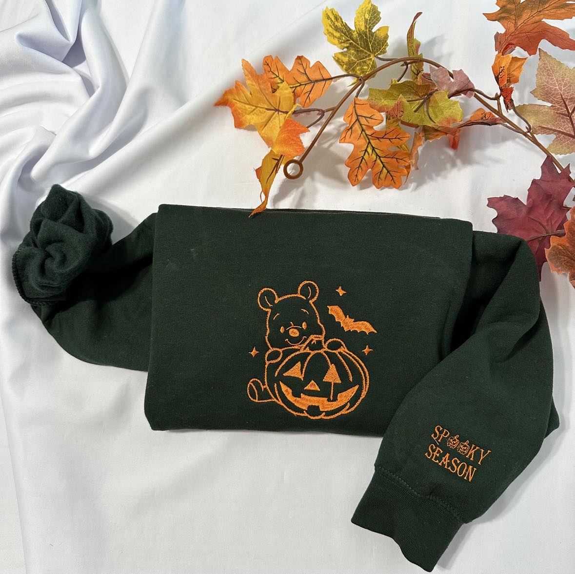 Halloween Winnie the Pooh embroidered sweatshirt with a spooky season embroidered on the cuff; Halloween Pumpkin embroidered sweatshirt