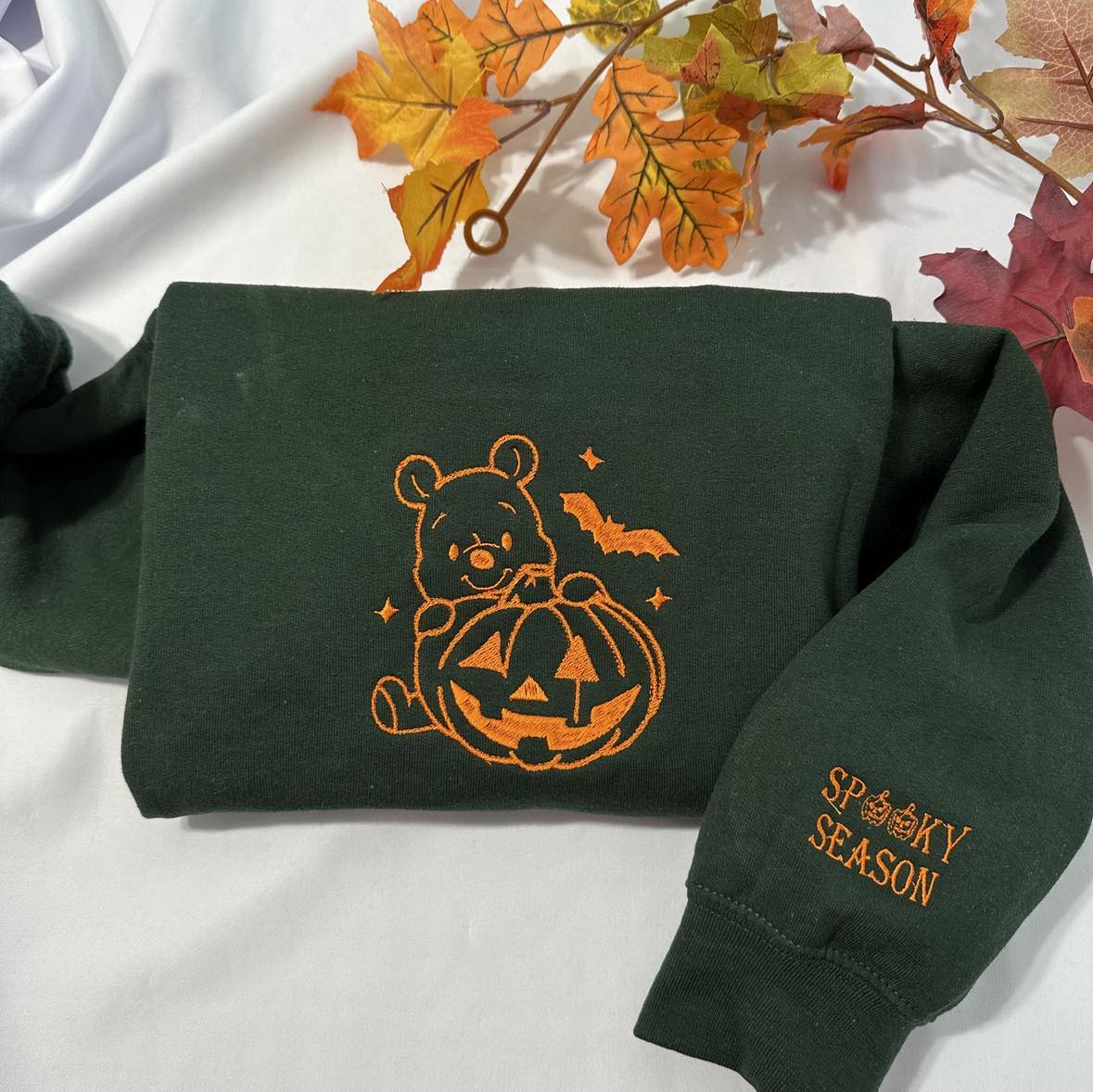 Halloween Winnie the Pooh embroidered sweatshirt with a spooky season embroidered on the cuff; Halloween Pumpkin embroidered sweatshirt