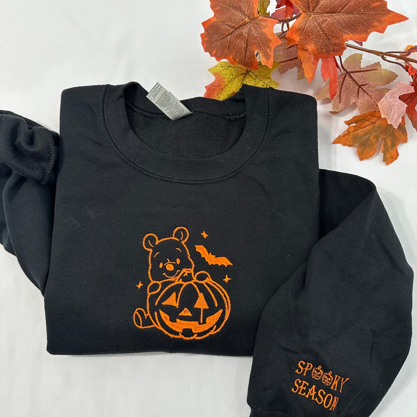 Halloween Winnie the Pooh embroidered sweatshirt with a spooky season embroidered on the cuff; Halloween Pumpkin embroidered sweatshirt